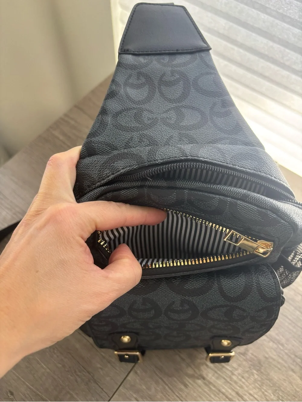 Black Sling Backpack with Signature Pattern